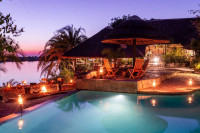 Watch the sunset as you sit around a campfire under the open sky