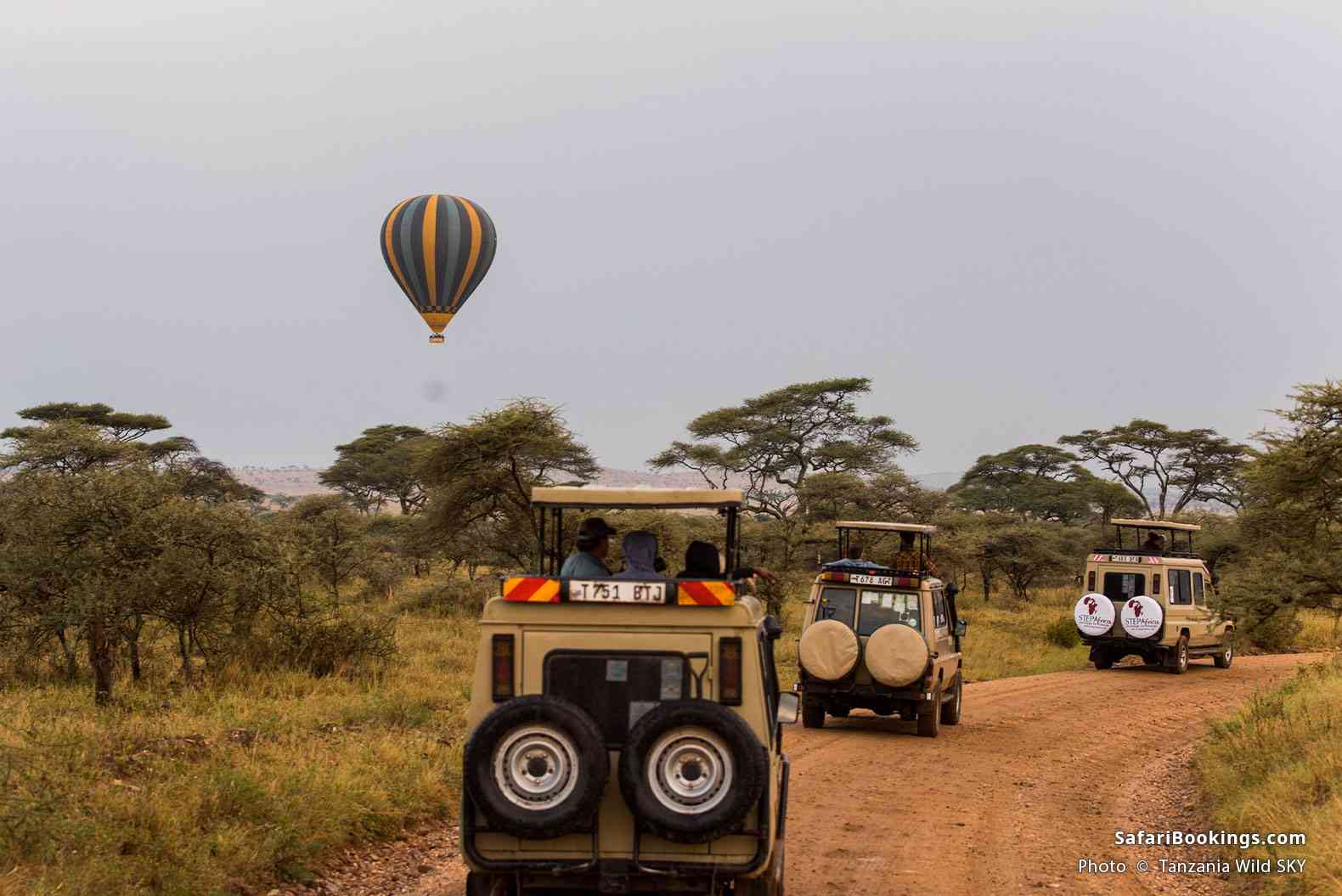 Safari vehicles and a hot-air balloon in Serengeti