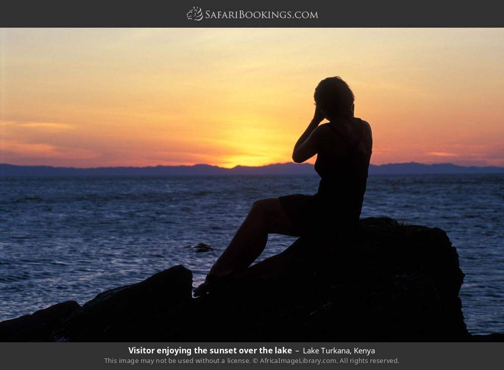 Visitor enjoying the sunset over the lake in Lake Turkana, Kenya