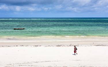 Maasai walking on the beach