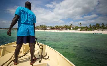 Boat guide on a snorkeling trip preparing to anchor