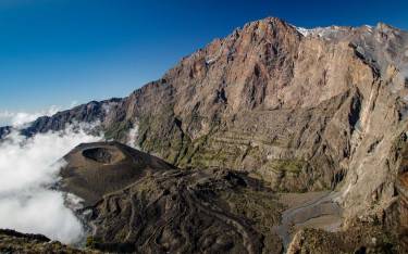 Mt Meru and its ash cone above the clouds