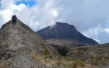 Hikers on Mt Meru with a backdrop of Little Meru