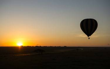 Hot-air balloon safari at sunrise