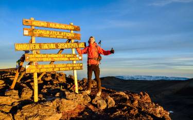Hiker at the summit of Mt Kilimanjaro