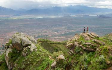 Tourist and guide taking in the view of the Pare Mountains from Mambo