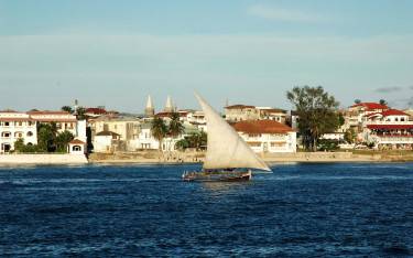 Traditional dhow sailing past Stone Town