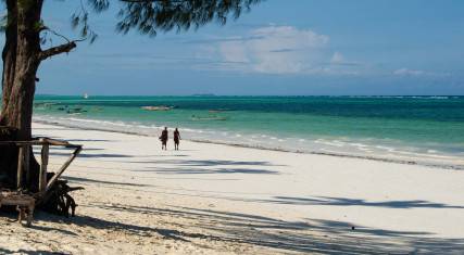 Maasai walking on the beach