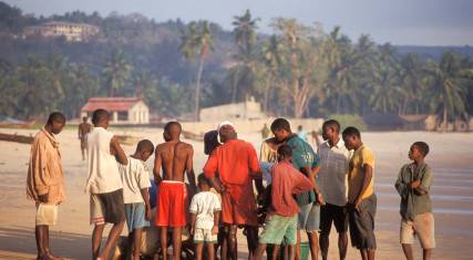People buying fish on the beach